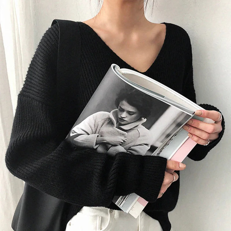 Person holding a magazine with a black and white photo of a woman on the cover. #Color_Black